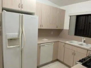 a kitchen with a sink and a refrigerator