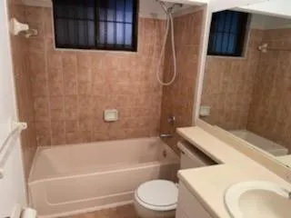 a bathroom with a toilet and a tub
