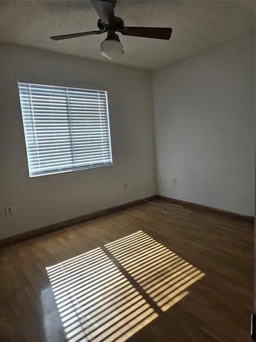 a view of a room with wooden floor and windows