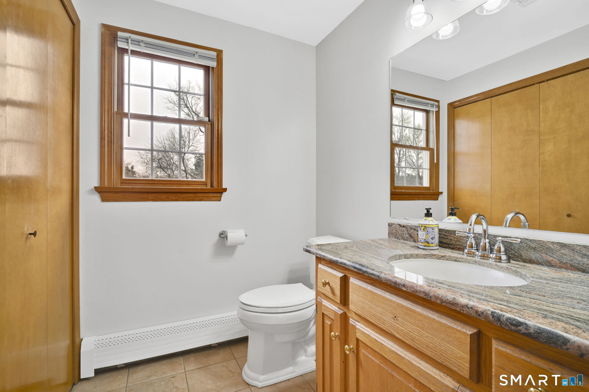 36 Cardinal Way South Windsor, CT 06074 - Photo 20 of 40 a bathroom with a granite countertop sink toilet and mirror