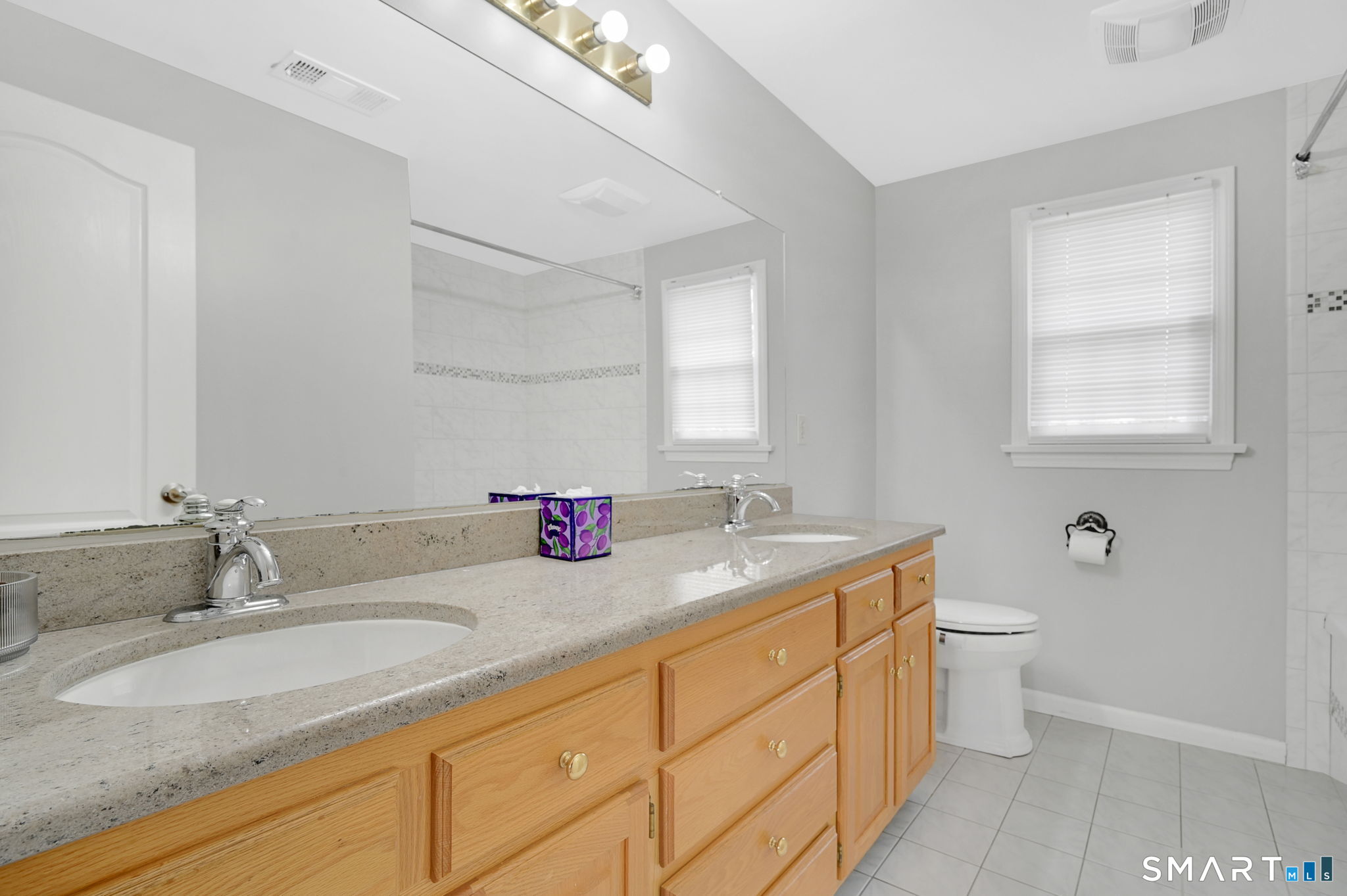 36 Cardinal Way South Windsor, CT 06074 - Photo 26 of 40 a bathroom with a granite countertop double vanity sink a mirror and a toilet
