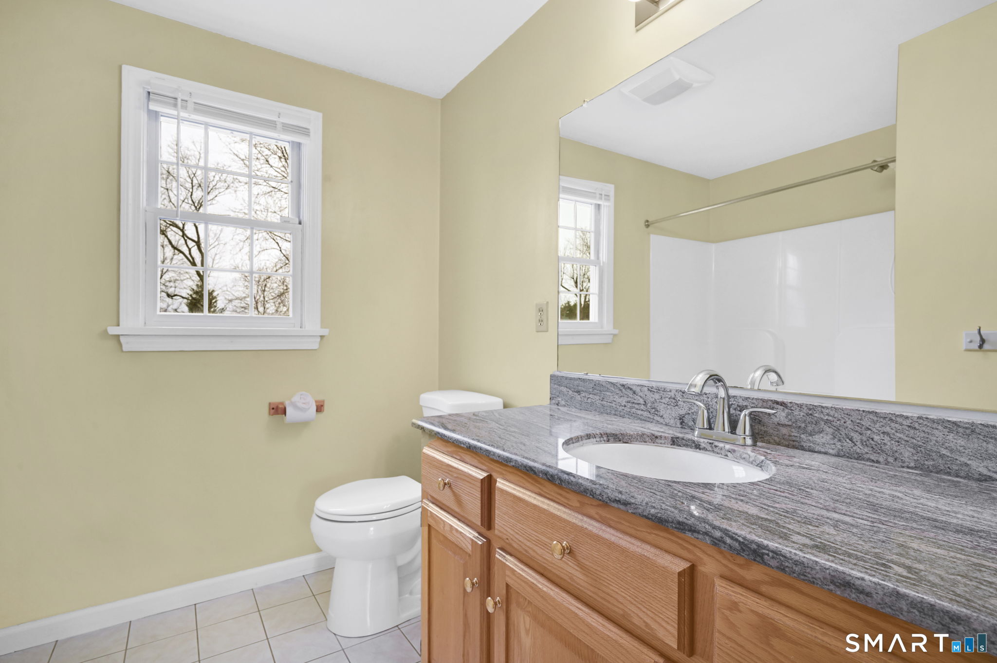 36 Cardinal Way South Windsor, CT 06074 - Photo 32 of 40 a bathroom with a granite countertop sink a toilet and a mirror