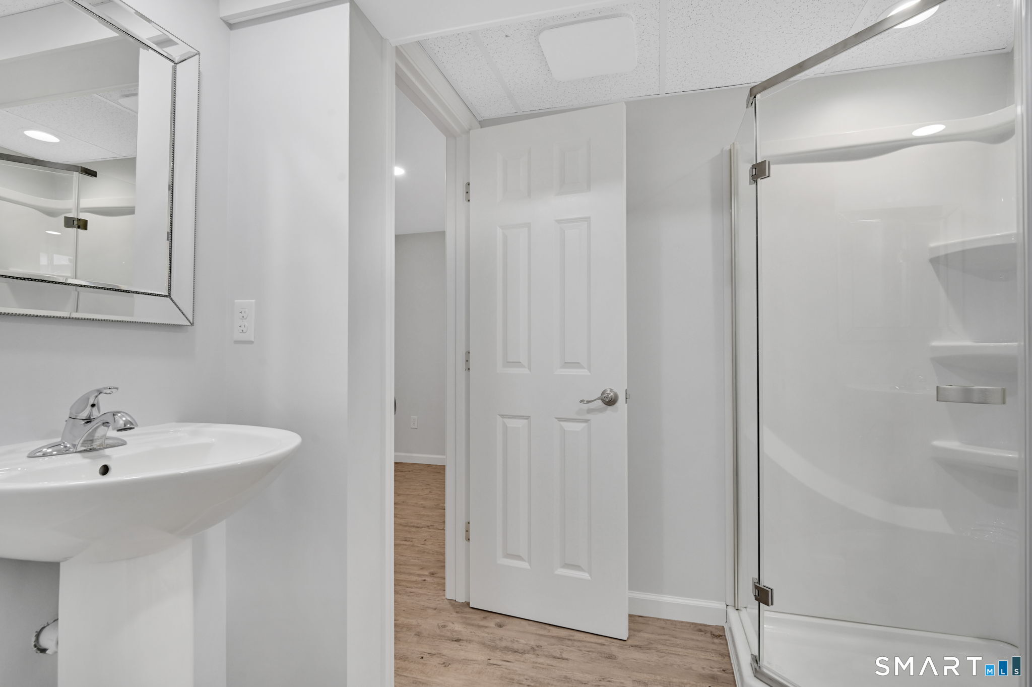 36 Cardinal Way South Windsor, CT 06074 - Photo 37 of 40 a bathroom with a sink a mirror and a shower