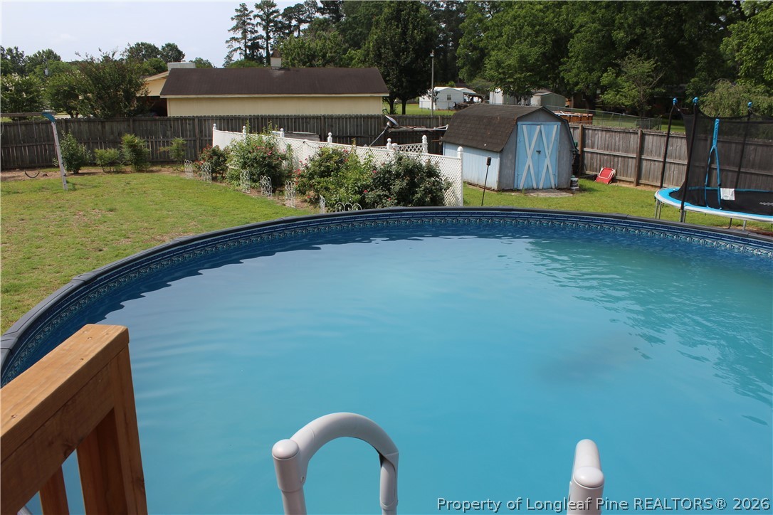 2038 Dunn Road Eastover, NC 28312 - Photo 28 of 29 a view of a house with a backyard and a patio