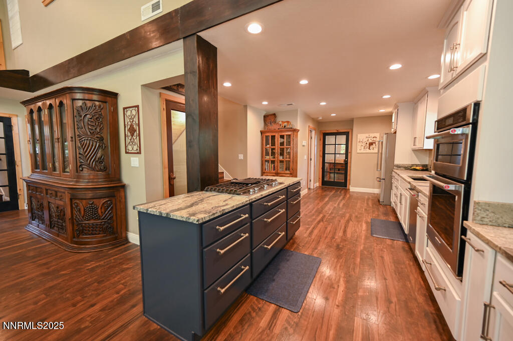 1147 Autumn Hills Road Gardnerville, NV 89460 - Photo 12 of 50 a kitchen with stainless steel appliances granite countertop a stove and a refrigerator
