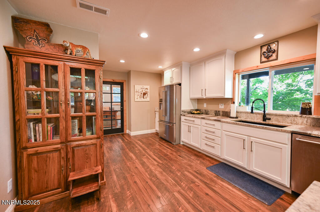 1147 Autumn Hills Road Gardnerville, NV 89460 - Photo 16 of 50 a kitchen with stainless steel appliances granite countertop a refrigerator and wooden cabinets