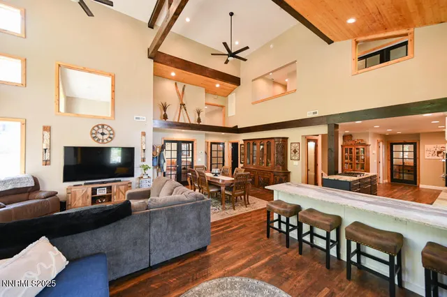 a bedroom with a bed and a flat tv screen on dresser