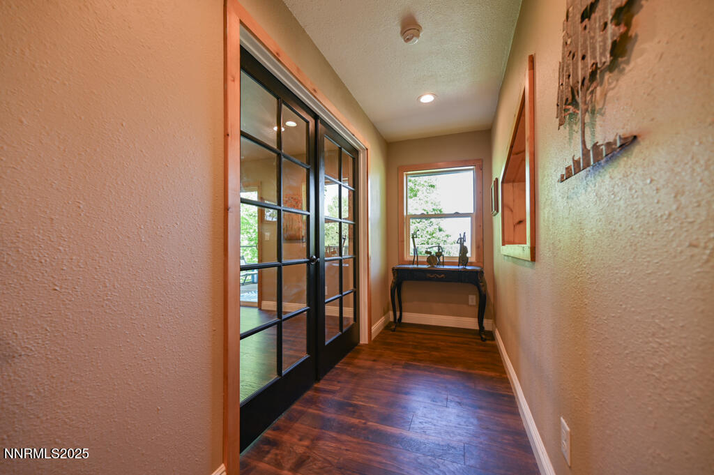 1147 Autumn Hills Road Gardnerville, NV 89460 - Photo 22 of 50 a view of a hallway with wooden floor and stairs