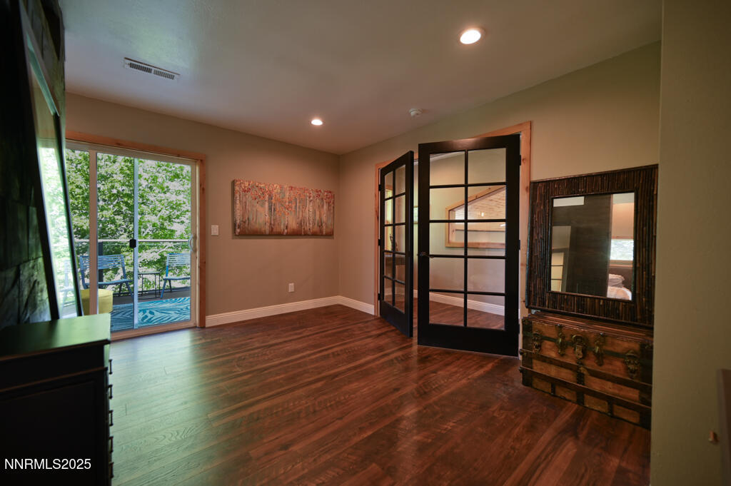 1147 Autumn Hills Road Gardnerville, NV 89460 - Photo 25 of 50 an empty room with wooden floor and windows