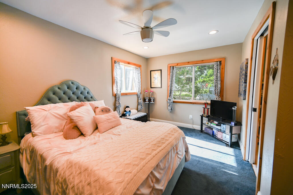 1147 Autumn Hills Road Gardnerville, NV 89460 - Photo 37 of 50 a bedroom with a large bed and a flat tv screen on dresser