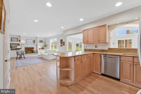 a kitchen with a sink cabinets and wooden floor