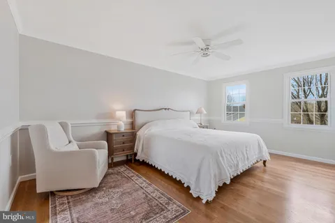 a bedroom with bed and windows