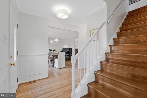 a view of entryway and hall with wooden floor