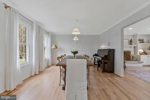 a living room with furniture a wooden floor and a large window