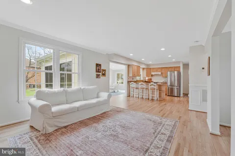 a living room with furniture and a table with wooden floor
