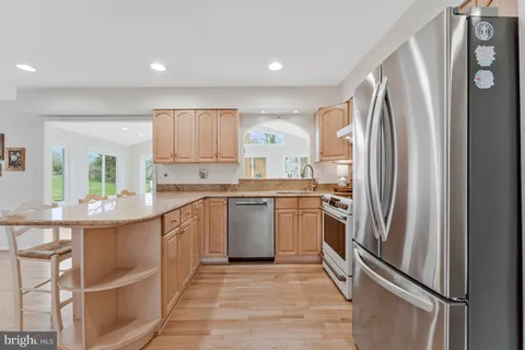 a kitchen with stainless steel appliances granite countertop a refrigerator and a sink
