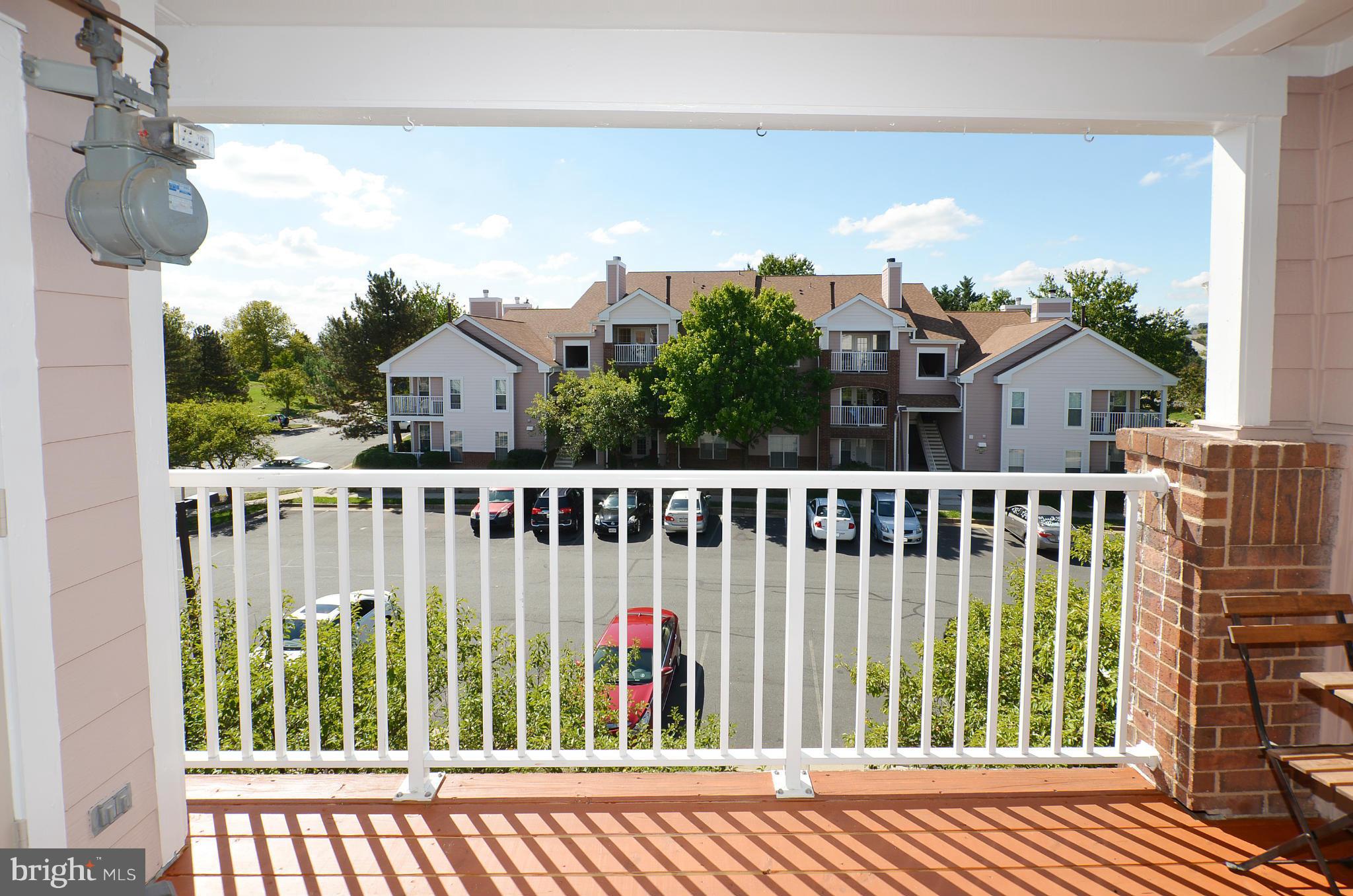 21019 Timber Ridge Terrace, Unit 302 Ashburn, VA 20147 - Photo 2 of 27 a view of a city from a balcony