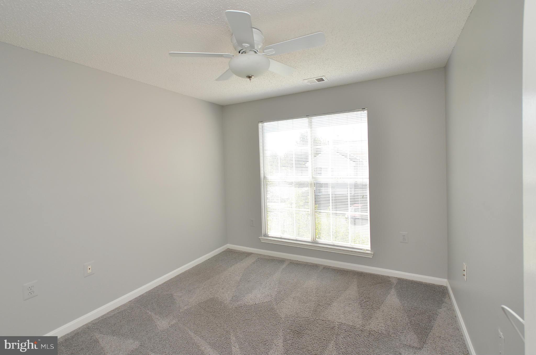 21019 Timber Ridge Terrace, Unit 302 Ashburn, VA 20147 - Photo 23 of 27 an empty room with a window