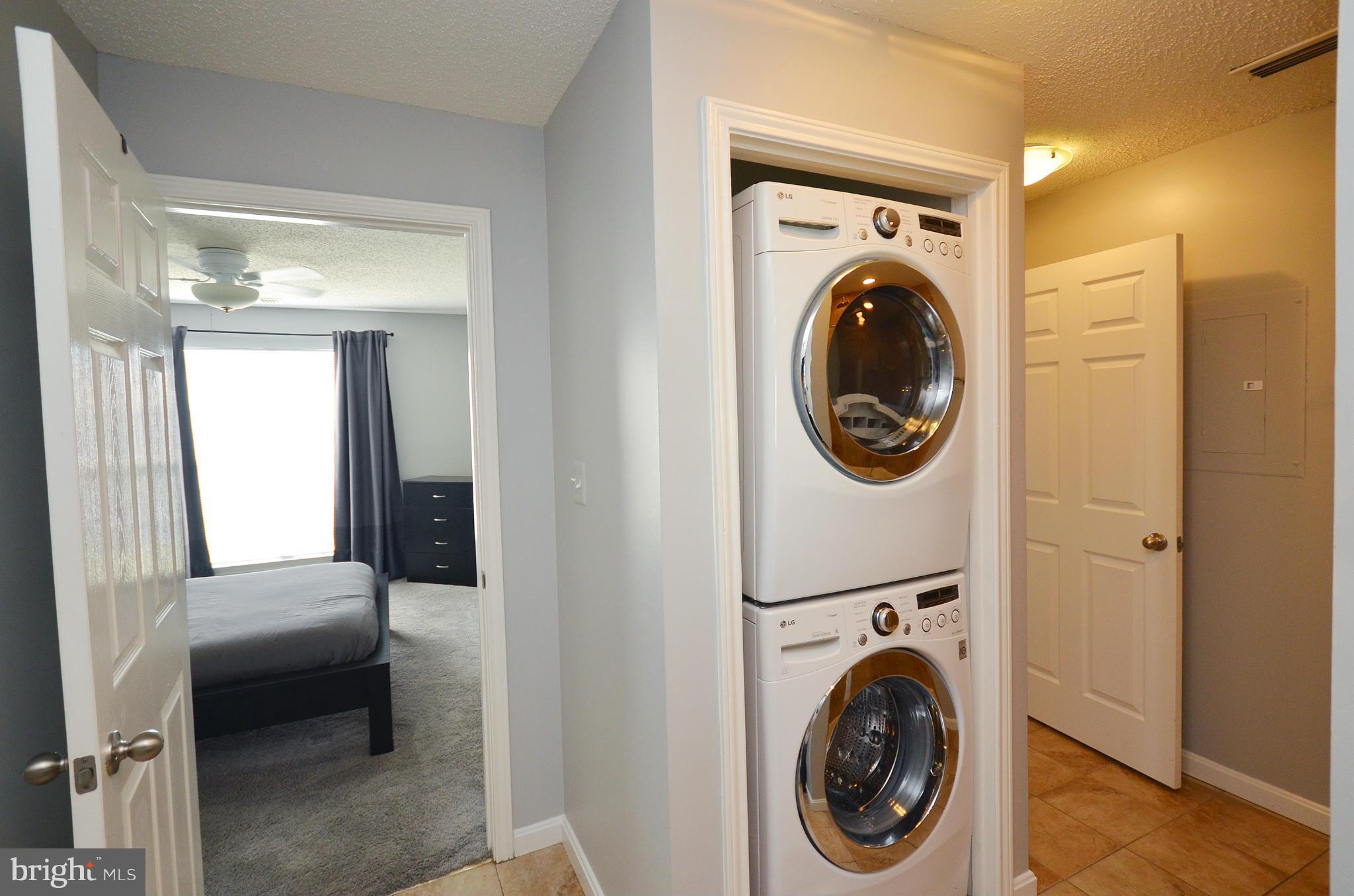 21019 Timber Ridge Terrace, Unit 302 Ashburn, VA 20147 - Photo 24 of 27 a utility room with dryer and washer