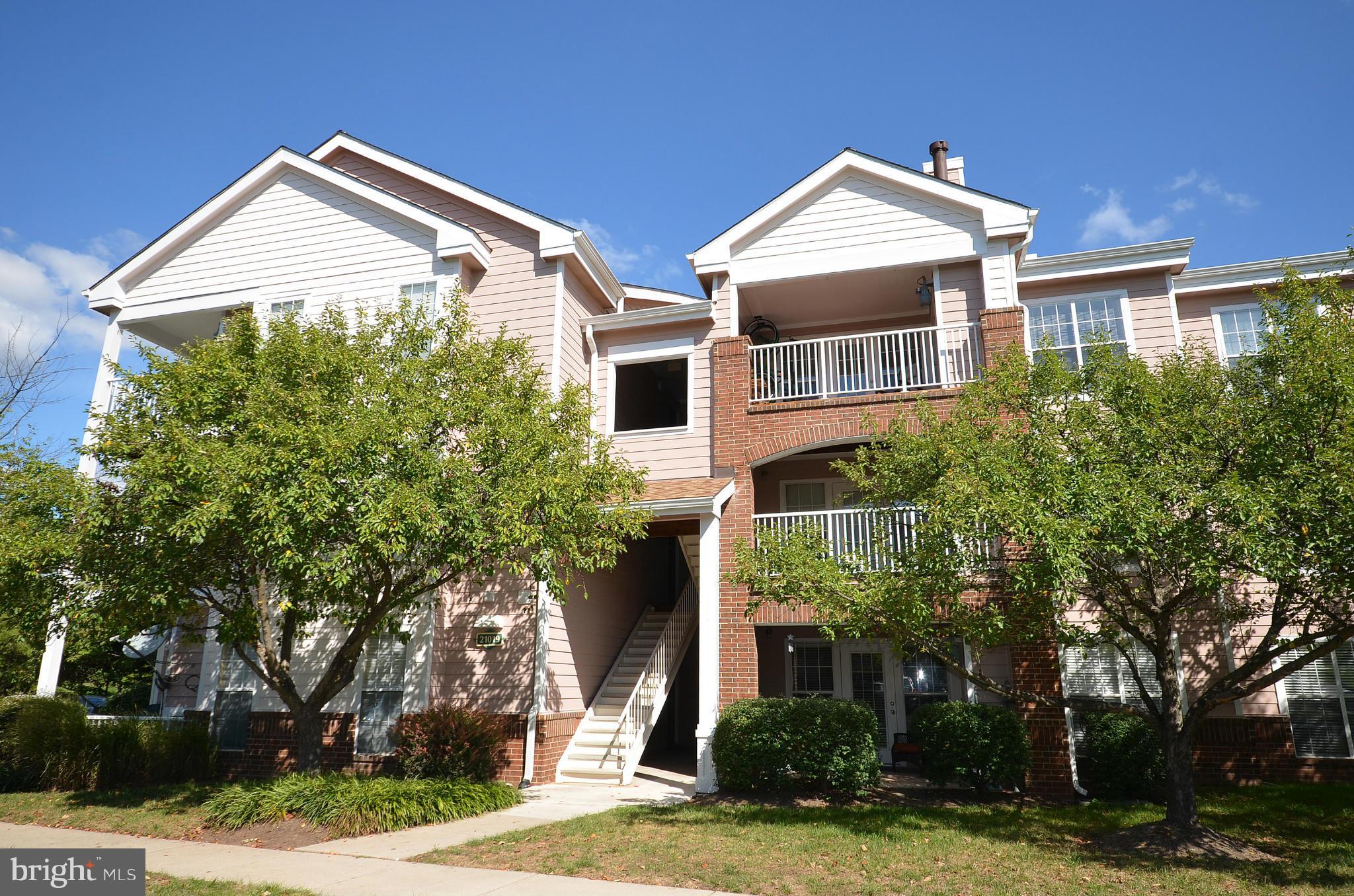 21019 Timber Ridge Terrace, Unit 302 Ashburn, VA 20147 - Photo 27 of 27 front view of house with a yard