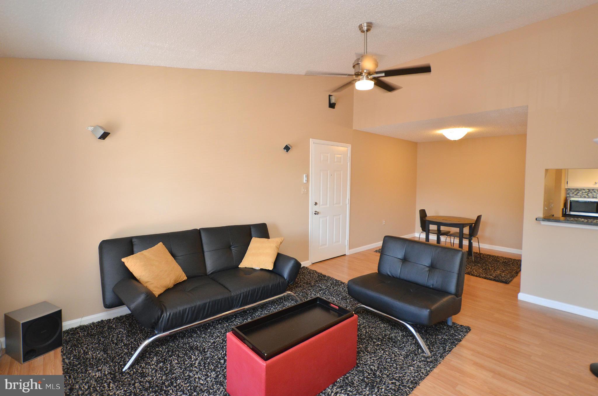 21019 Timber Ridge Terrace, Unit 302 Ashburn, VA 20147 - Photo 6 of 27 a blue kitchen with a stove and a refrigerator