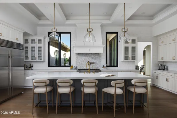 a kitchen with granite countertop a table chairs stove and cabinets