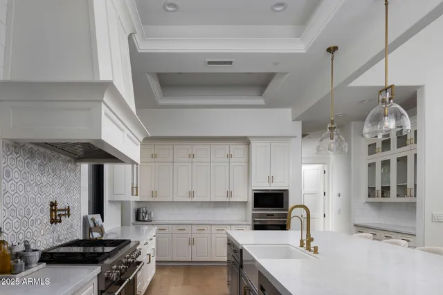 a kitchen with a sink appliances and cabinets