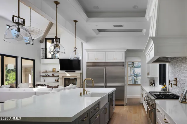 a kitchen with kitchen island a sink stove and refrigerator