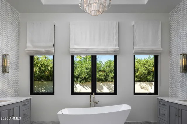 a bathroom with a sink a mirror and a window