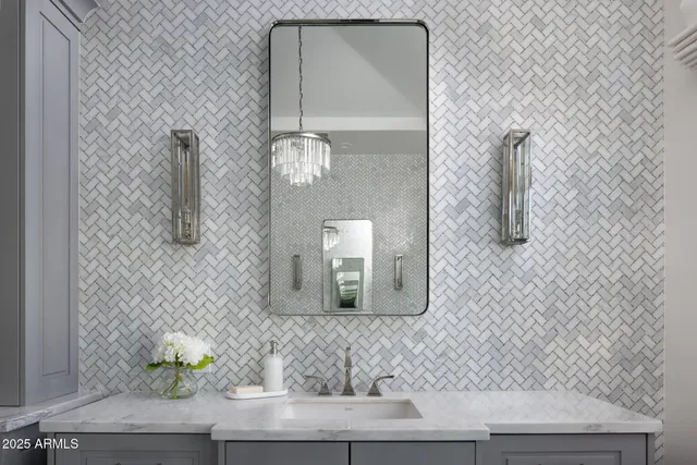 a bathroom with a granite countertop sink and a mirror