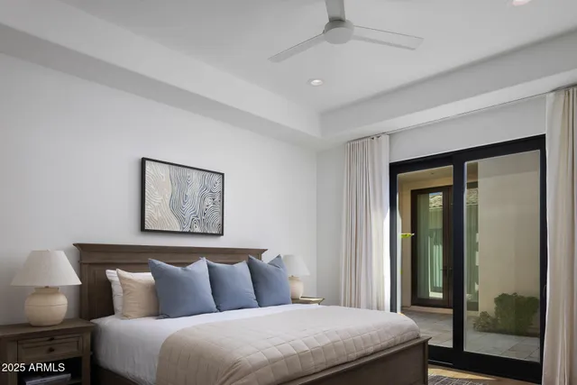 a bedroom with a large bed and a painting on the wall