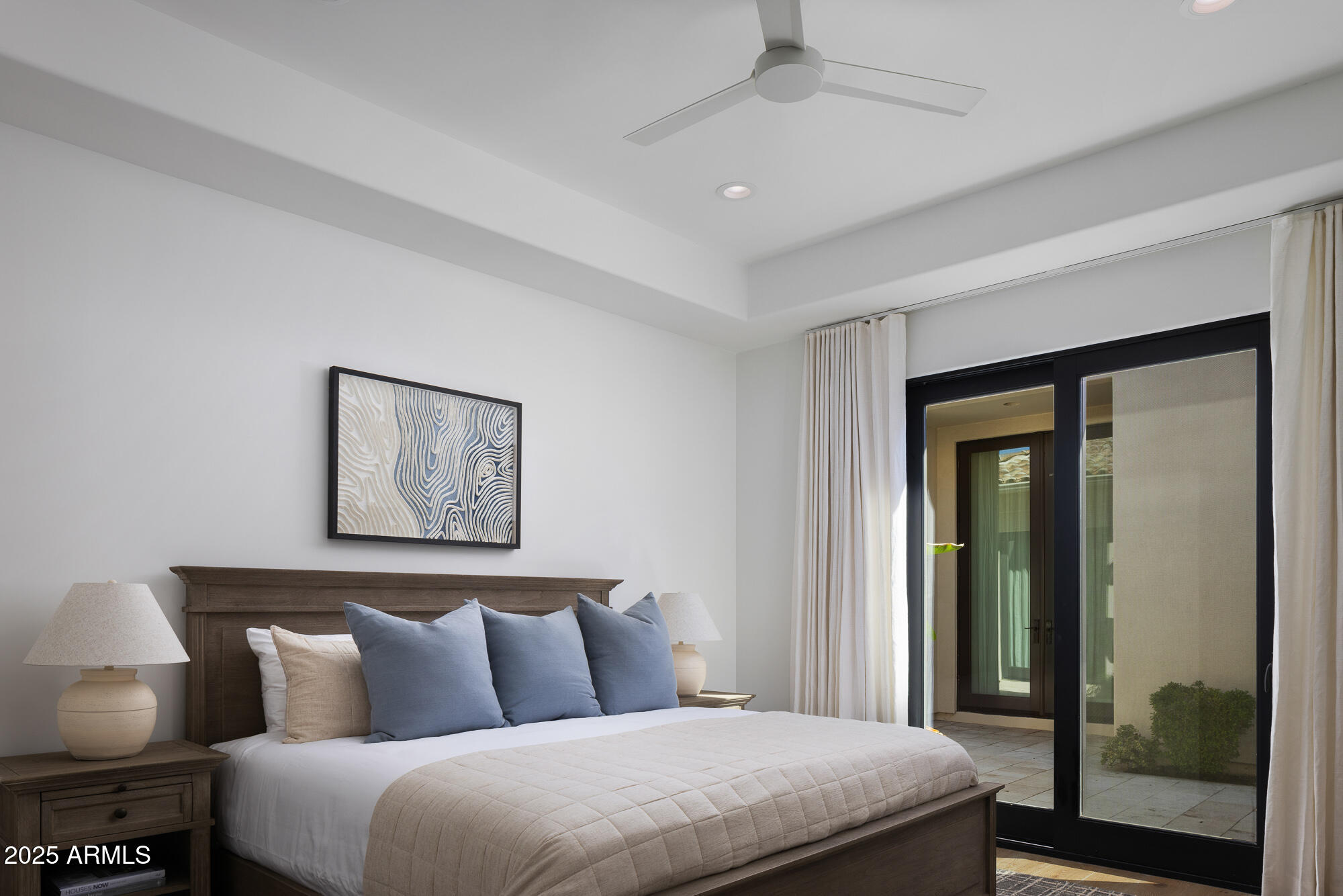 7730 North Mockingbird Lane Paradise Valley, AZ 85253 - Photo 20 of 42 a bedroom with a large bed and a painting on the wall