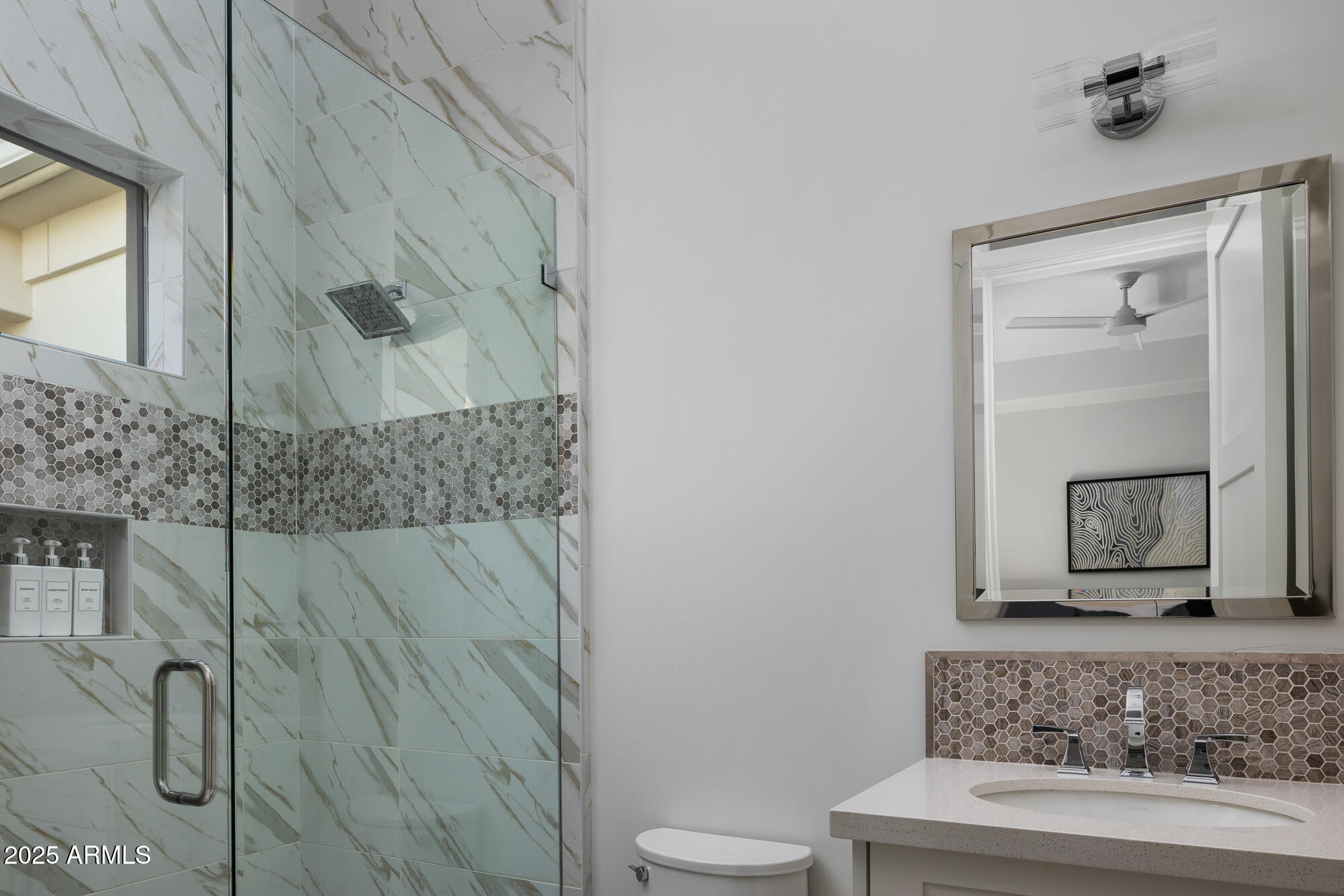 7730 North Mockingbird Lane Paradise Valley, AZ 85253 - Photo 21 of 42 a bathroom with a granite countertop sink a toilet and shower