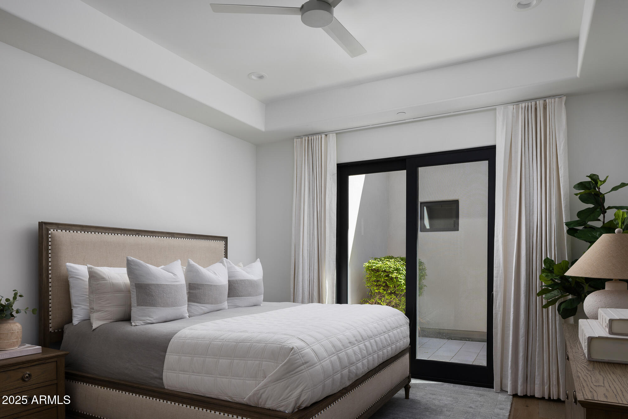 7730 North Mockingbird Lane Paradise Valley, AZ 85253 - Photo 22 of 42 a bedroom with a large bed and a potted plant