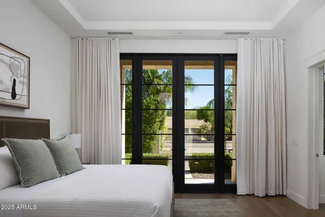 a bedroom with a large bed and a large window