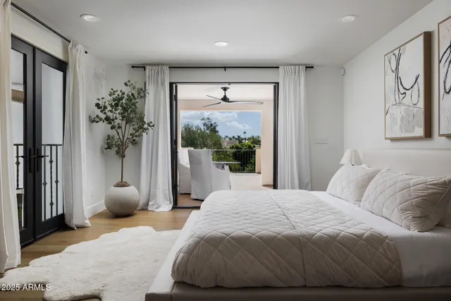 a bedroom with a bed and a large window