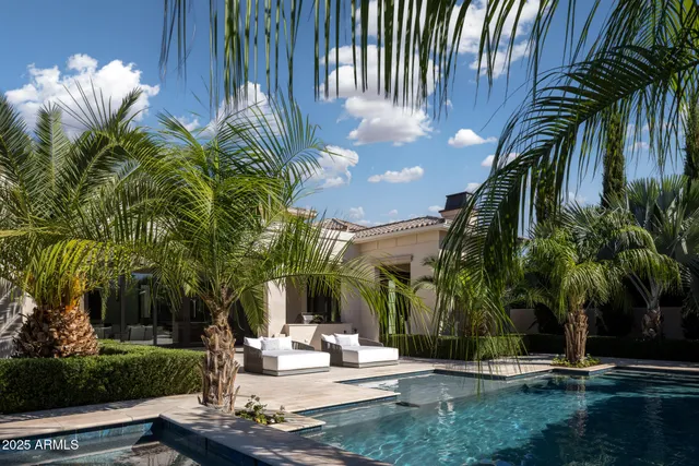 a view of a house with backyard and sitting area