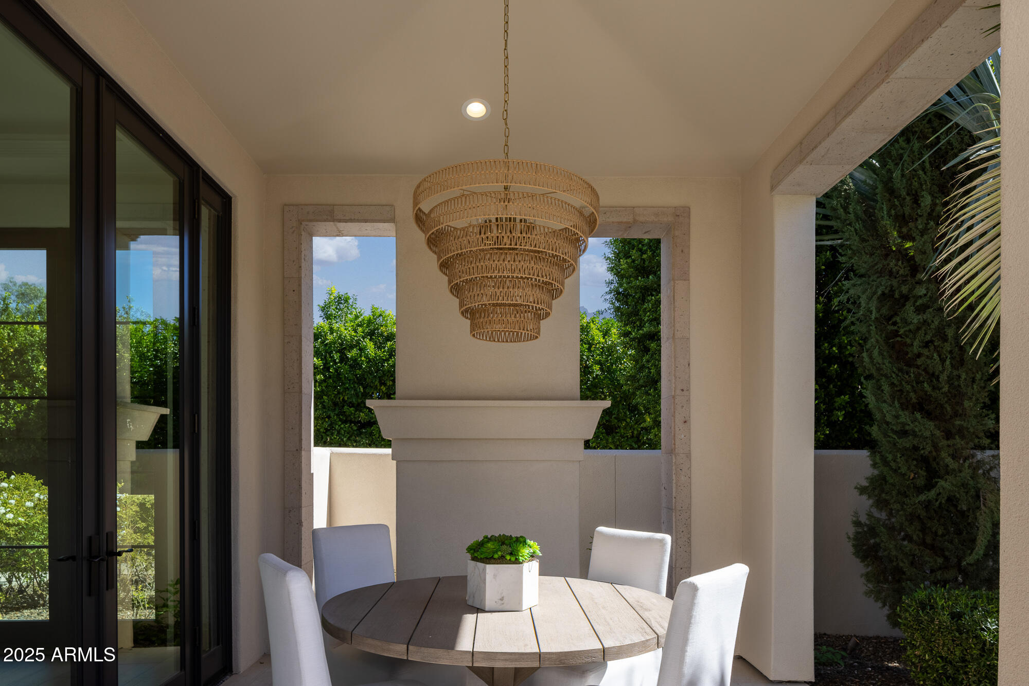 7730 North Mockingbird Lane Paradise Valley, AZ 85253 - Photo 34 of 42 a vase of flowers sitting on a table in front of a window