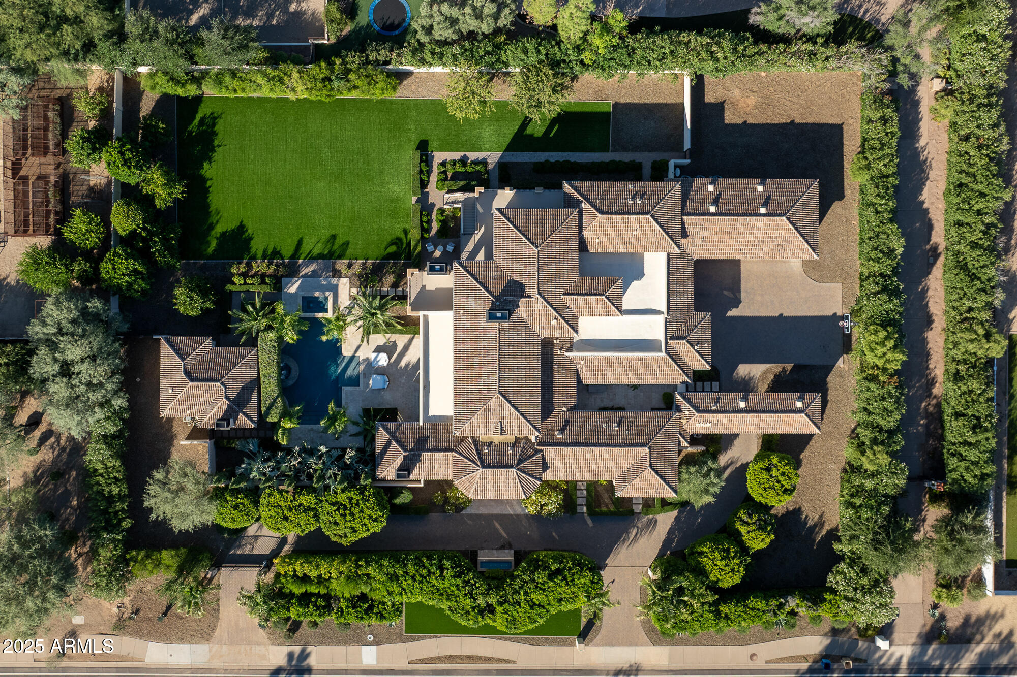 7730 North Mockingbird Lane Paradise Valley, AZ 85253 - Photo 4 of 42 an aerial view of a house with a garden and lake view