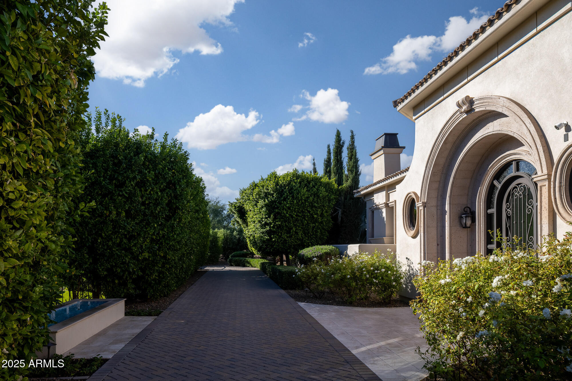 7730 North Mockingbird Lane Paradise Valley, AZ 85253 - Photo 5 of 42 a view of a multi story building with a yard