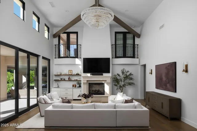 a living room with furniture a fireplace and a flat screen tv