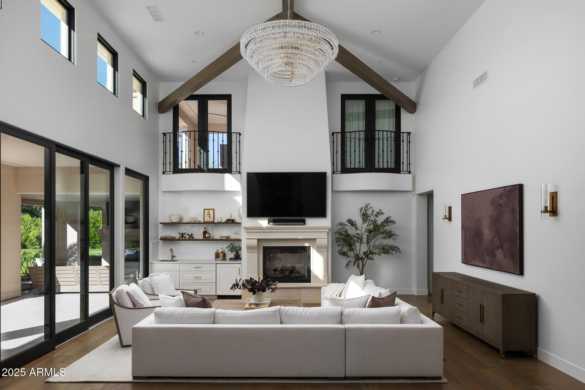 7730 North Mockingbird Lane Paradise Valley, AZ 85253 - Photo 7 of 42 a living room with furniture a fireplace and a flat screen tv