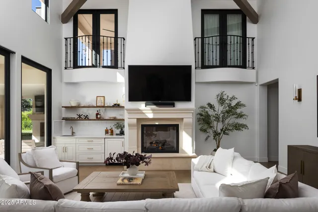 a living room with furniture fireplace and flat screen tv
