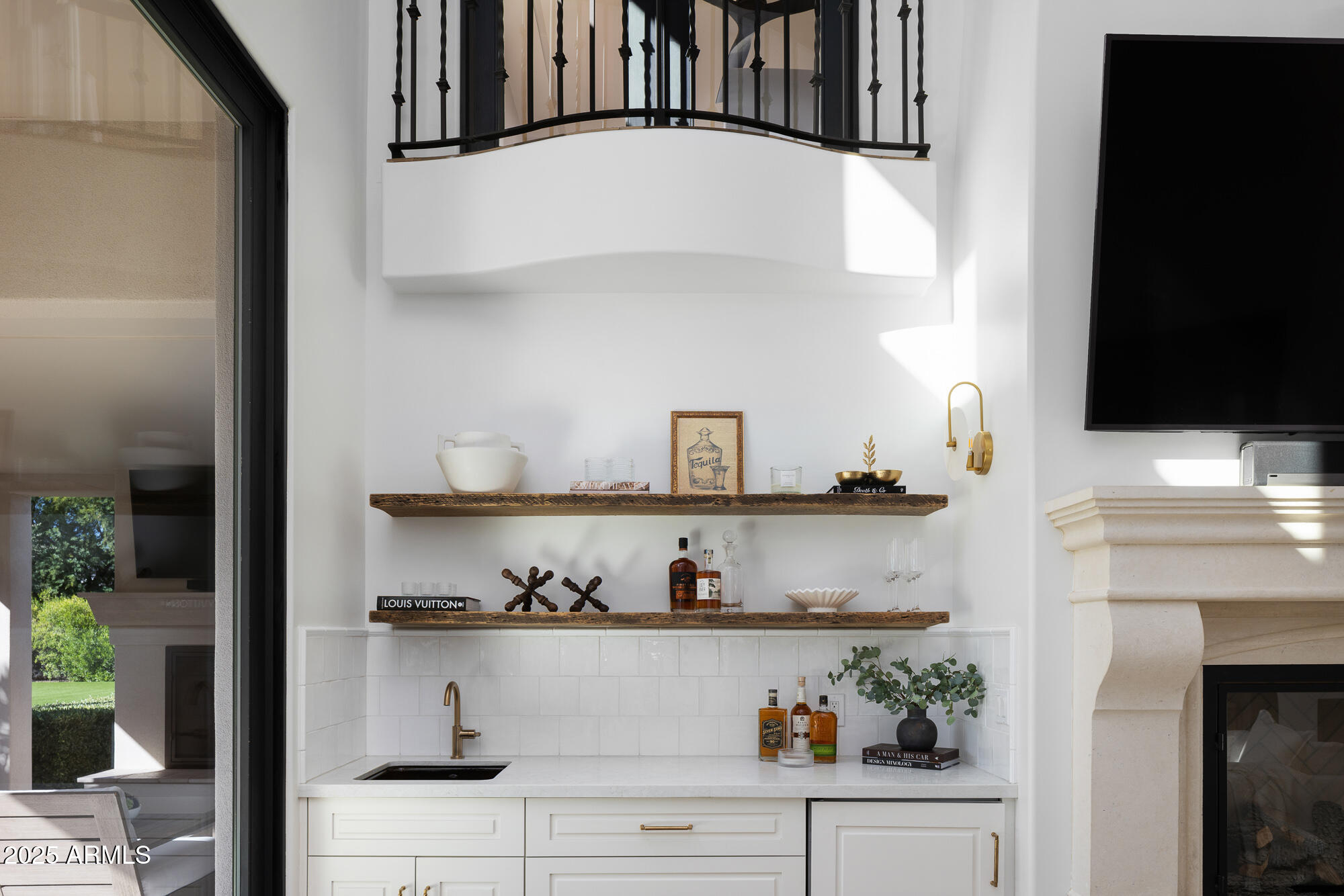 7730 North Mockingbird Lane Paradise Valley, AZ 85253 - Photo 9 of 42 a view of white cabinet with plants and knick knacks on it