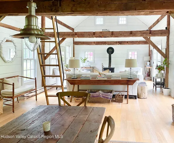 a living room with chairs and a table