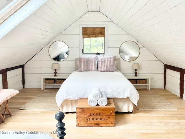 a bedroom with double bed and a wooden floor
