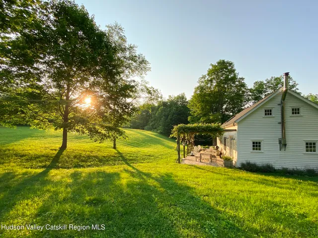 a view of backyard with table and chairs
