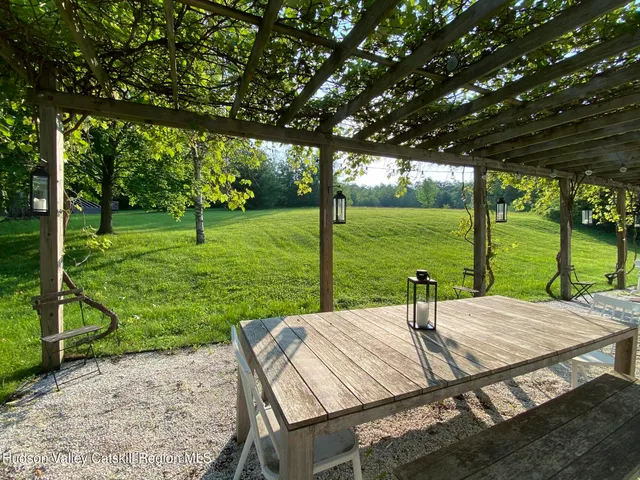 a view of a patio with a table chairs and a backyard