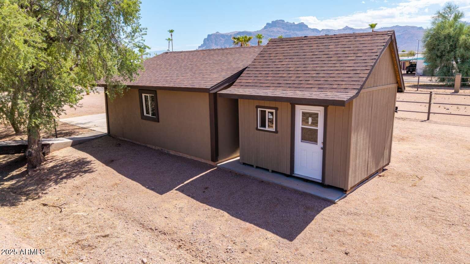2009 South Raindance Road Apache Junction, AZ 85119 - Photo 54 of 60 a view of a house with a yard and wooden fence