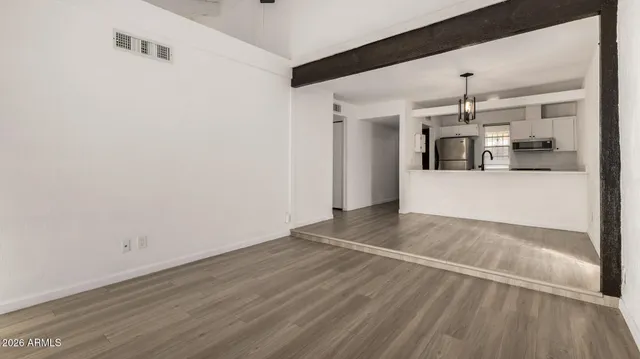 a view of a room with wooden floor and windows